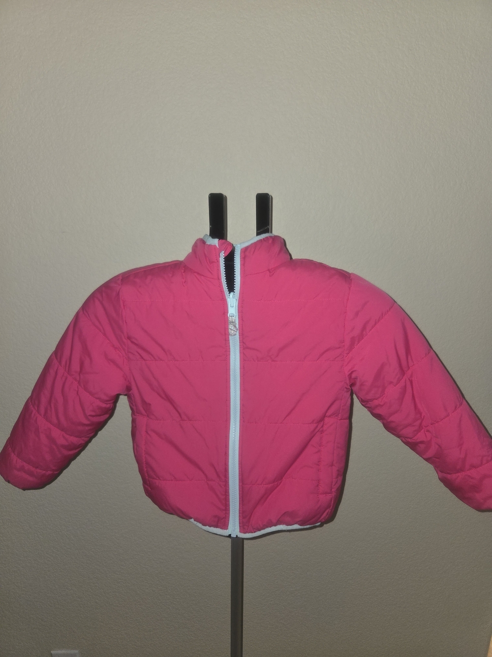 Bright Pink Puffer Jacket with Light Blue Trim. Reversible